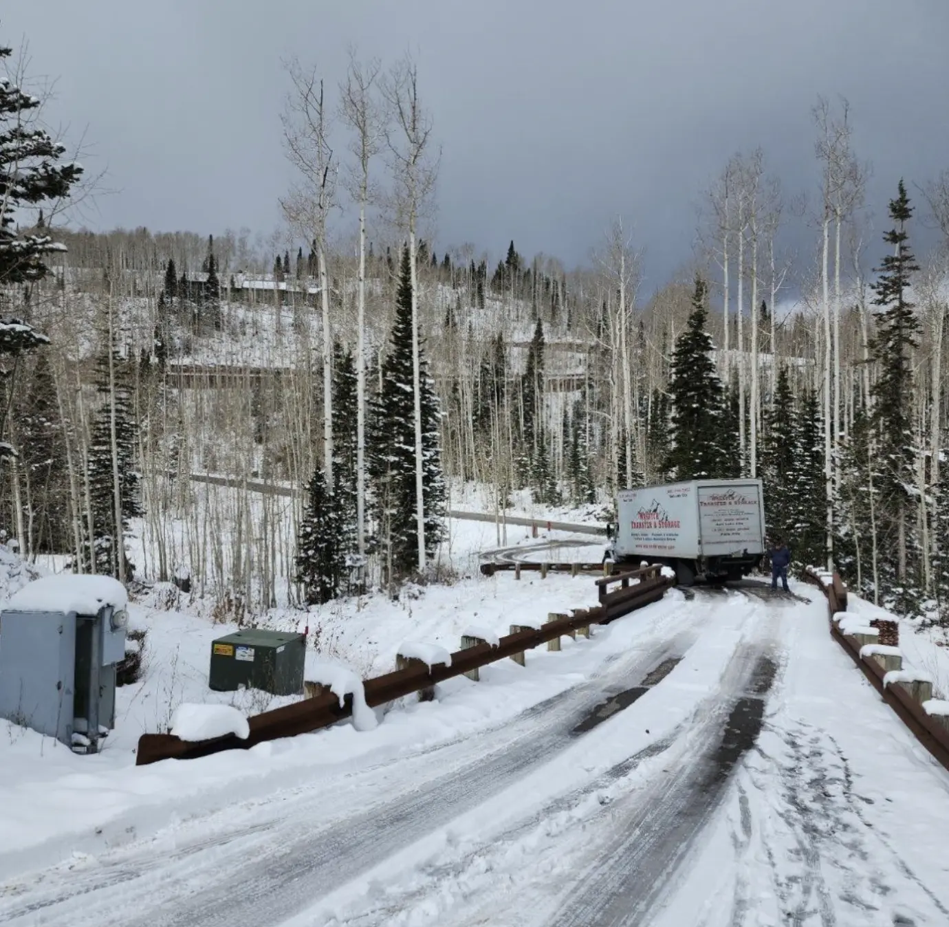 Wasatch Transfer moving truck driving on a snowy Park City road for Utah long distance moves